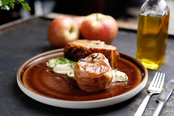 Pork ribs baked with apples served on a plate.
Culinary photography. Suggestion to serve the dish.