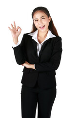 Asian woman wearing black suit against a white background isolated winks an eye and holds an okay gesture with hand. Concept Ok success.