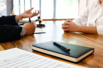 Lawyer Legal counsel presents to the client a signed contract with gavel and legal law. justice and lawyer Business partnership meeting concept.