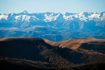 Mountain Hills on the background of Mountain Ranges with white snow caps. Mountain Gorge. The concept of Travel, Nature