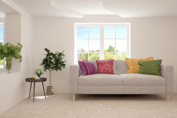 White living room with sofa and summer landscape in window. Scandinavian interior design. 3D illustration