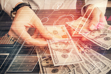 Double exposure of technology drawing hologram and us dollars bills and man hands. Data concept