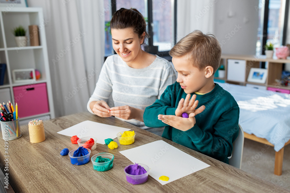 Canvas Prints family, creativity and craft concept - mother and little son playing with modeling clay at home