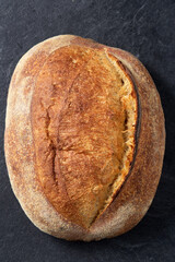 food, baking and cooking concept - homemade craft bread on table