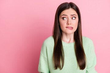 Photo of terrified person bite lip look empty space wear sweater isolated on pink color background
