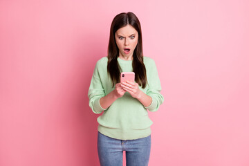 Photo of impressed attractive person staring screen open mouth unexpected wear sweater isolated on pink color background