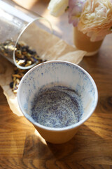 Cappuccino in a paper cup and with powdered sugar on top