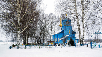rural wooden Orthodox church among the trees