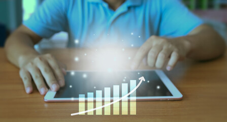 The hand of an enterprise employee using a tablet to analyze business data. Corporate growth concept Development and creation of sustainable goals.