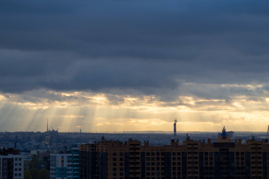 Sun Rays In Sky Clouds Over Industrial Urban City