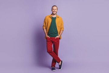 Close up portrait of handsome business man guy posing hands pockets on purple wall