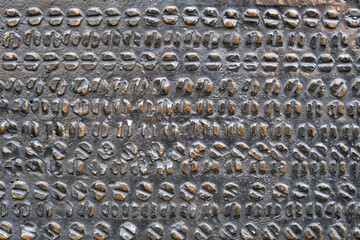 Background image: Black metal with embossed gold-colored elements in the form of geometric shapes.