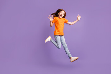 Fototapeta na wymiar Full length body size view of lovely cheerful pre-teen girl jumping walking good mood isolated over violet purple color background