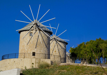 Fototapeta na wymiar old windmill with blue sky in alacati, cesme Izmir