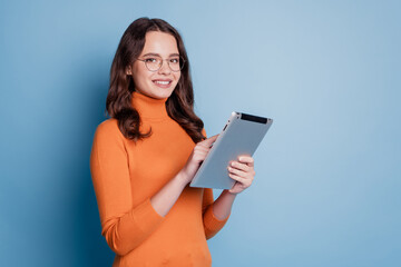Photo of positive business woman hold ebook shiny white smile look camera work posing on blue background