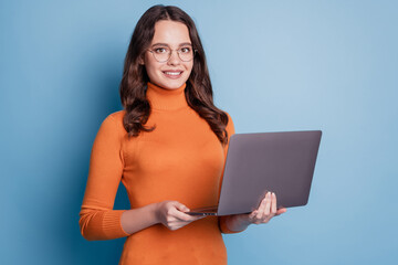 Photo of freelancer manager lady hold netbook shiny smile posing on blue background