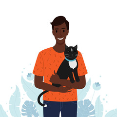 Men holds his pet cat in his arms.
