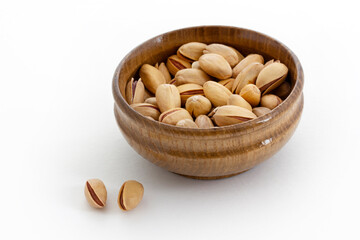 Fresh pistachios in a bamboo plate. Food background.