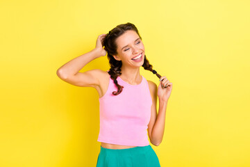 Photo of charming nice brunette young woman touch hair braids summer relax isolated on vivid yellow color background