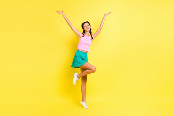 Fototapeta na wymiar Full body photo of happy attractive young woman raise hands wear summer outfit isolated on vivid yellow color background