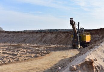 Huge mining excavator in the sand open-pit. Biggest digger working in quarry. Largest tracked machine with electric shovel. Heavy duty electric-powered mining equipment