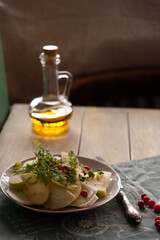 Homemade fresh Fennel salad on dark background with olive oil.  Salad with fennel, green apple, chervil, olive oil and cranberries is good for spring and winter diet.