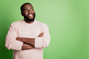 Photo of clever pensive self-assured man folded hands look empty space wear white shirt over green background