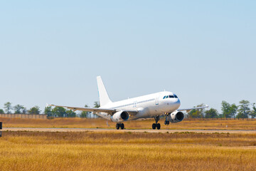 Fototapeta premium Passenger plane takes off from runway in airport
