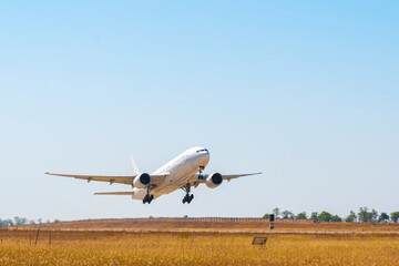 Fototapeta na wymiar Passenger plane takes off from runway in airport