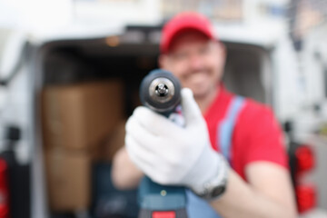 Smiling male master builder holding drill closeup