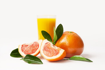 Grapefruit juice glass with whole grapefruit, slices and leaves isolated on white background. Fresh citrus fruit.