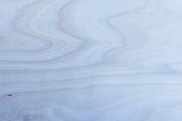 Toned blue wood cut or plywood surface - light background closeup