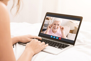 Unrecognizable Female Communicating With Her Elderly Mother Via Video Call On Laptop