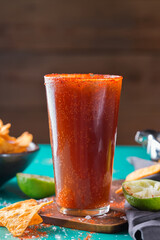 Mexican alcohol cocktail michelada with dark beer and lime juice