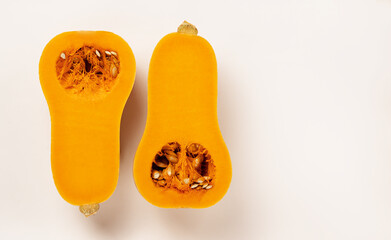Flatlay of Fresh butternut squash cut in half isolated on white background. Healthy food.Tasty vegetables. Banner with place for text