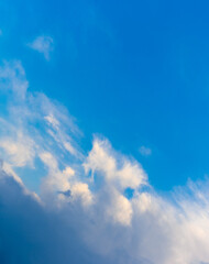 White clouds in the blue sky are located diagonally