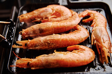 Grilled large shrimps with lemon and spices on the grill pan