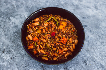 vegan quinoa risotto with sweet potatoes capsicum and green beans in spicy tomato sauce, healthy plant-based food