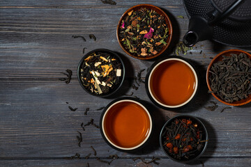 assortment of fragrant tea. black, floral and herbal drinks on wooden background, top view