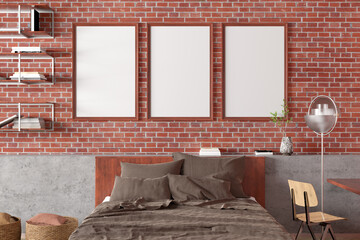 Three vertical blank poster frames mock up on the red brick wall in interior of loft bedroom.