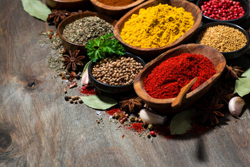 assortment of various spices and herbs on a wooden table