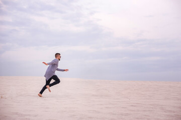 Man running on the sand at sunset