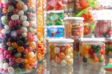 Different kinds of sweetness in glass jars. Marmalade, lollipops, sweets of juicy flowers
