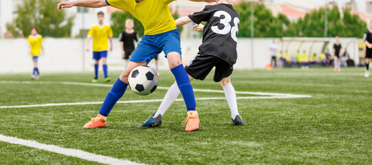 Football Kids Playing Game. Two Players in Opposing Teams in a Duel. Soccer Compatition in Youth Soccer League