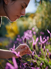 Young girl picking up lavender flowers