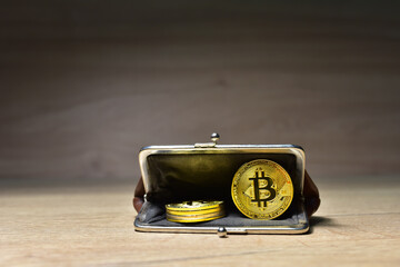 Bitcoin coin in wallet for carrying money and coins. Сryptocurrency trading exchange. BTC mining and investing concept. Blockchain and financial technology. Crypto prices and market capitalization
