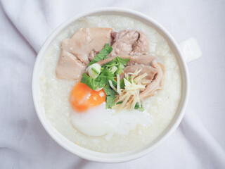 Top view of Rice porridge with minced pork, sliced ginger