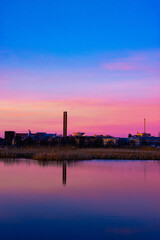 Fototapeta premium sunset over the city with many industry buildings and factories. 