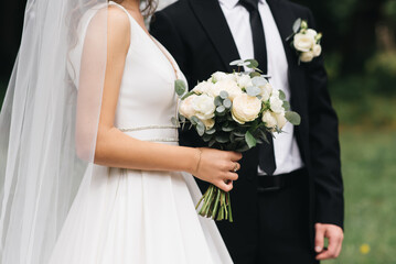 Wedding photo day. The bride and groom hold hands