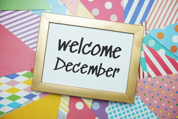 Welcome December text on colorful background